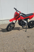Red kids 36V electric dirt bike side view

Model CS3288 electric motocross bike for kids

Rear disc brake and suspension on 300W dirt bike

Young rider electric toy motorcycle CS3288

Knobby off-road tires on kids 36V electric bike
