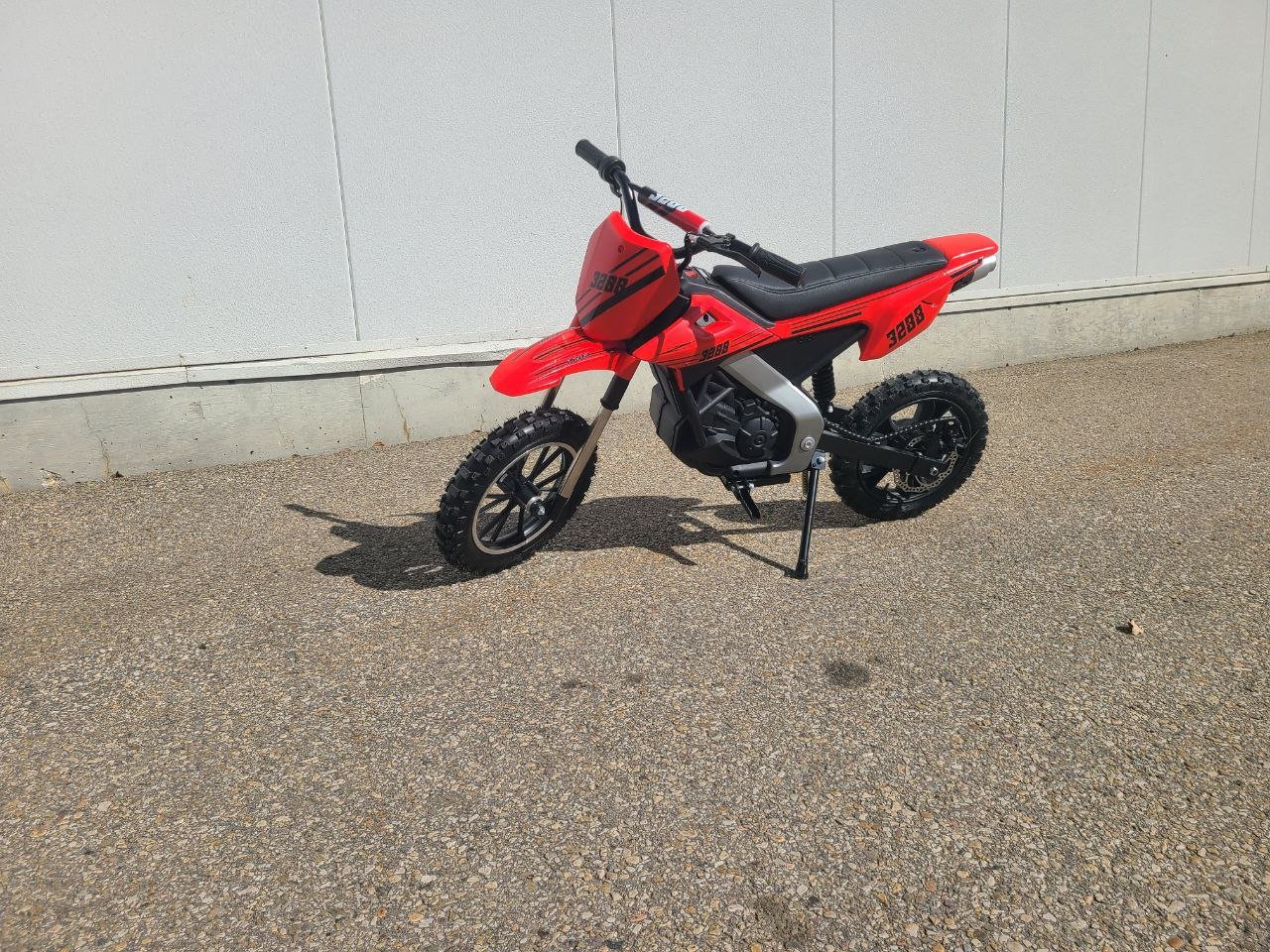 Red kids 36V electric dirt bike side view

Model CS3288 electric motocross bike for kids

Rear disc brake and suspension on 300W dirt bike

Young rider electric toy motorcycle CS3288

Knobby off-road tires on kids 36V electric bike