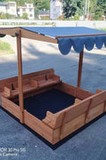 Wooden sandbox with canopy fully extended and benches visible

Close-up of sandbox lid cover in closed position

Children playing inside wooden sandbox with canopy

Side angle showing bench detail and canopy fabric

Folded sandbox closed with protective cover on top