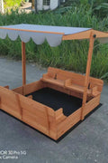 Wooden sandbox with canopy fully extended and benches visible

Close-up of sandbox lid cover in closed position

Children playing inside wooden sandbox with canopy

Side angle showing bench detail and canopy fabric

Folded sandbox closed with protective cover on top