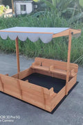 Wooden sandbox with canopy fully extended and benches visible

Close-up of sandbox lid cover in closed position

Children playing inside wooden sandbox with canopy

Side angle showing bench detail and canopy fabric

Folded sandbox closed with protective cover on top