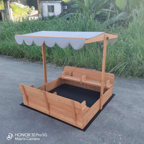 Wooden sandbox with canopy fully extended and benches visible

Close-up of sandbox lid cover in closed position

Children playing inside wooden sandbox with canopy

Side angle showing bench detail and canopy fabric

Folded sandbox closed with protective cover on top