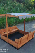 Wooden sandbox with canopy fully extended and benches visible

Close-up of sandbox lid cover in closed position

Children playing inside wooden sandbox with canopy

Side angle showing bench detail and canopy fabric

Folded sandbox closed with protective cover on top