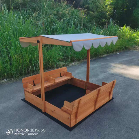 Wooden sandbox with canopy fully extended and benches visible

Close-up of sandbox lid cover in closed position

Children playing inside wooden sandbox with canopy

Side angle showing bench detail and canopy fabric

Folded sandbox closed with protective cover on top