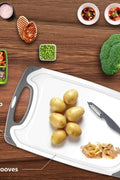 Plastic kitchen cutting boards with anti-slip handles and bonus knife

4-piece BPA-free cutting board set with juice grooves

Non-slip cutting board set in various sizes with stainless steel knife

Easy-grip chopping board set for meat, veggies, and fruits