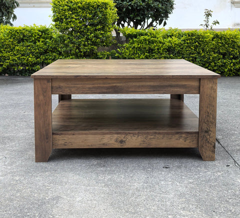 Rustic knotty oak coffee table in a farmhouse-style living room
Side view showing woodgrain texture and lower shelf
Top-down view of the square table surface
Decorated coffee table with books and storage baskets
Compact rustic wood table styled with cozy furniture