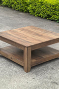 Rustic knotty oak coffee table in a farmhouse-style living room
Side view showing woodgrain texture and lower shelf
Top-down view of the square table surface
Decorated coffee table with books and storage baskets
Compact rustic wood table styled with cozy furniture