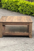 Rustic knotty oak coffee table in a farmhouse-style living room
Side view showing woodgrain texture and lower shelf
Top-down view of the square table surface
Decorated coffee table with books and storage baskets
Compact rustic wood table styled with cozy furniture