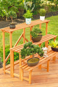 Front view of 4FT 3-tier wooden plant stand

Rustic wooden plant display shelf for outdoor use

Three-tier plant stand holding potted plants

Indoor wooden plant organizer with brown finish

Collapsible garden display rack for patio and balcony