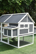 Large gray wooden chicken coop with nesting box and run for backyard poultry