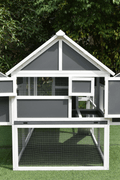 Gray backyard chicken run with multiple access points and predator-proof design