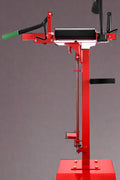Manual tire changer and spreader stand with red base and swivel platform
Tire changer stand showing adjustable tilt function and tool tray
Manual tire repair stand for light truck tires in auto repair garage