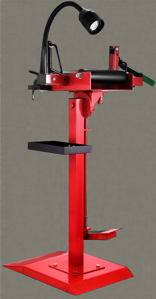 Manual tire changer and spreader stand with red base and swivel platform
Tire changer stand showing adjustable tilt function and tool tray
Manual tire repair stand for light truck tires in auto repair garage