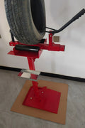 Manual tire changer and spreader stand with red base and swivel platform
Tire changer stand showing adjustable tilt function and tool tray
Manual tire repair stand for light truck tires in auto repair garage