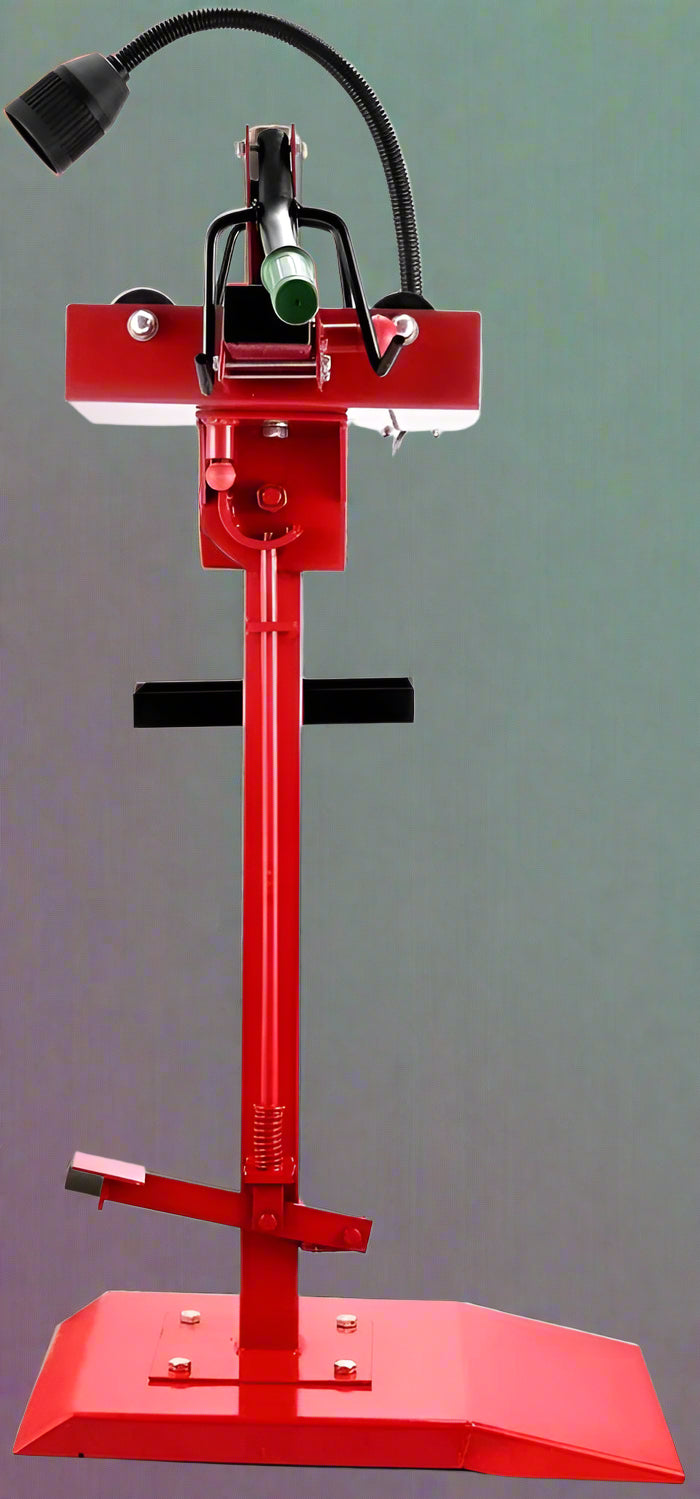 Manual tire changer and spreader stand with red base and swivel platform
Tire changer stand showing adjustable tilt function and tool tray
Manual tire repair stand for light truck tires in auto repair garage