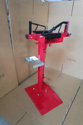 Manual tire changer and spreader stand with red base and swivel platform
Tire changer stand showing adjustable tilt function and tool tray
Manual tire repair stand for light truck tires in auto repair garage