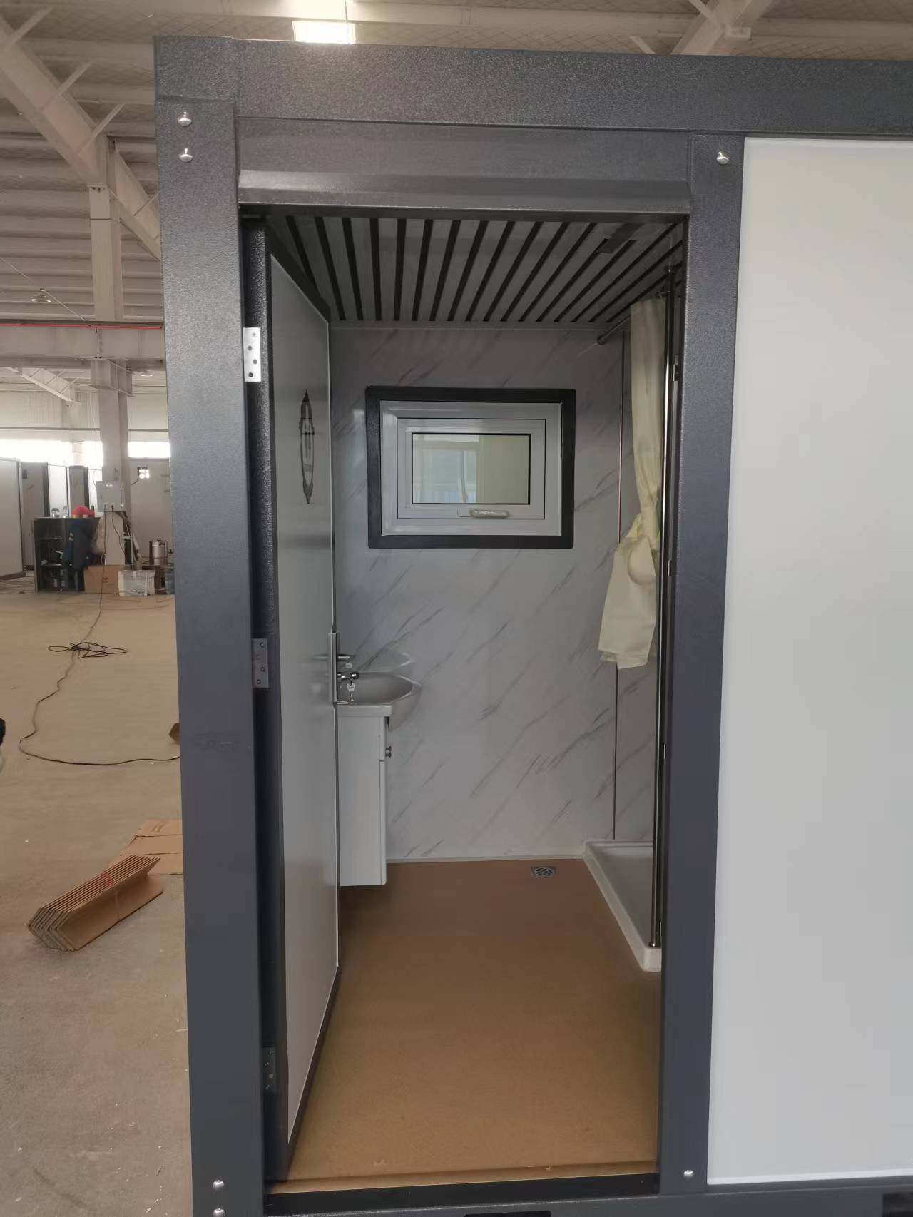 Gray single toilet portable restroom trailer
Double stall mobile toilet unit for construction use
Interior view of portable washroom with sink
Mobile shower unit with privacy enclosure
Pre-installed fixtures inside portable toilet and shower model