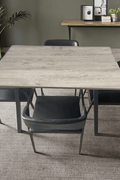 5-piece modern dining set with grey tabletop and black leather chairs
Rectangular grey dining table with black padded chairs