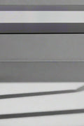 Close-up of black tempered glass tabletop with chrome legs