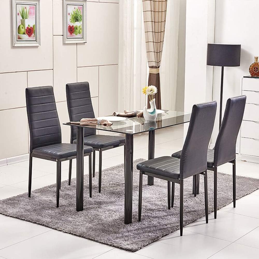 Modern black glass dining table with white leather chairs in dining room setting