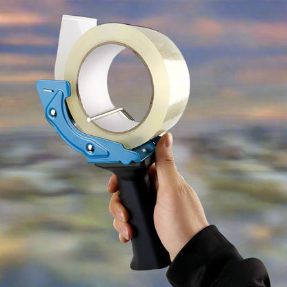 Mouse trap style tape gun in hand during use

Tape gun dispenser with ergonomic grip and metal body

Close-up of T250426 heavy-duty tape gun loading area

Heavy-duty black and blue packing tape dispenser

Shipping tape dispenser shown with standard tape roll

