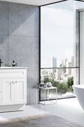 Modern white shaker vanity with marble top and single sink in styled bathroom setting – Newport series