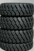 Heavy-duty E-3/L3 bias ply loader tire on warehouse floor

Rock lug pattern close-up for traction

20.5-25 loader tire tread and sidewall view

Mining OTR tire mounted on equipment

Rugged loader tire for industrial applications