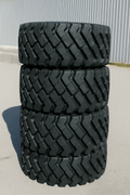 Heavy-duty E-3/L3 bias ply loader tire on warehouse floor

Rock lug pattern close-up for traction

20.5-25 loader tire tread and sidewall view

Mining OTR tire mounted on equipment

Rugged loader tire for industrial applications