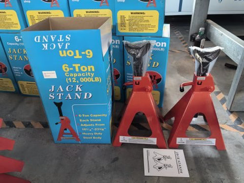 “Pair of red heavy-duty jack stands on concrete garage floor”

“6-ton jack stands with ratchet and locking pin”

“12-ton jack stands supporting heavy-duty pickup truck”