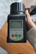 Digital grain moisture tester showing LCD screen readings

MT2599 grain tester with large sample chamber

Portable moisture meter for field and warehouse use

Moisture tester measuring corn sample

Digital analyzer for wheat, rice, cocoa, and coffee beans