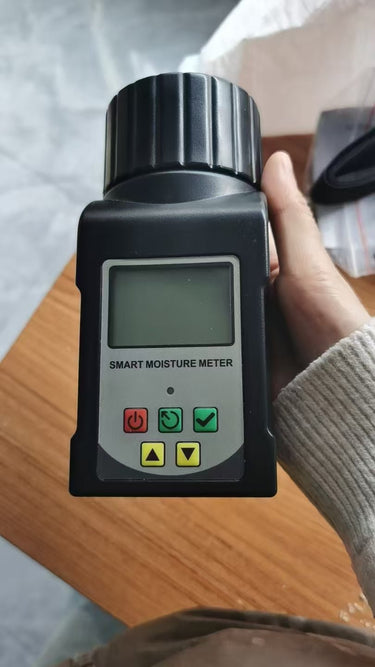 Digital grain moisture tester showing LCD screen readings

MT2599 grain tester with large sample chamber

Portable moisture meter for field and warehouse use

Moisture tester measuring corn sample

Digital analyzer for wheat, rice, cocoa, and coffee beans