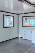 Exterior view of 2-bedroom deluxe folding house

Modern prefabricated orange modular home

Inside view of compact folding prefab unit

Kitchen area with electric setup in prefab home

Folding house with porch roof kit variant