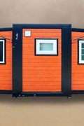 Exterior view of 2-bedroom deluxe folding house

Modern prefabricated orange modular home

Inside view of compact folding prefab unit

Kitchen area with electric setup in prefab home

Folding house with porch roof kit variant