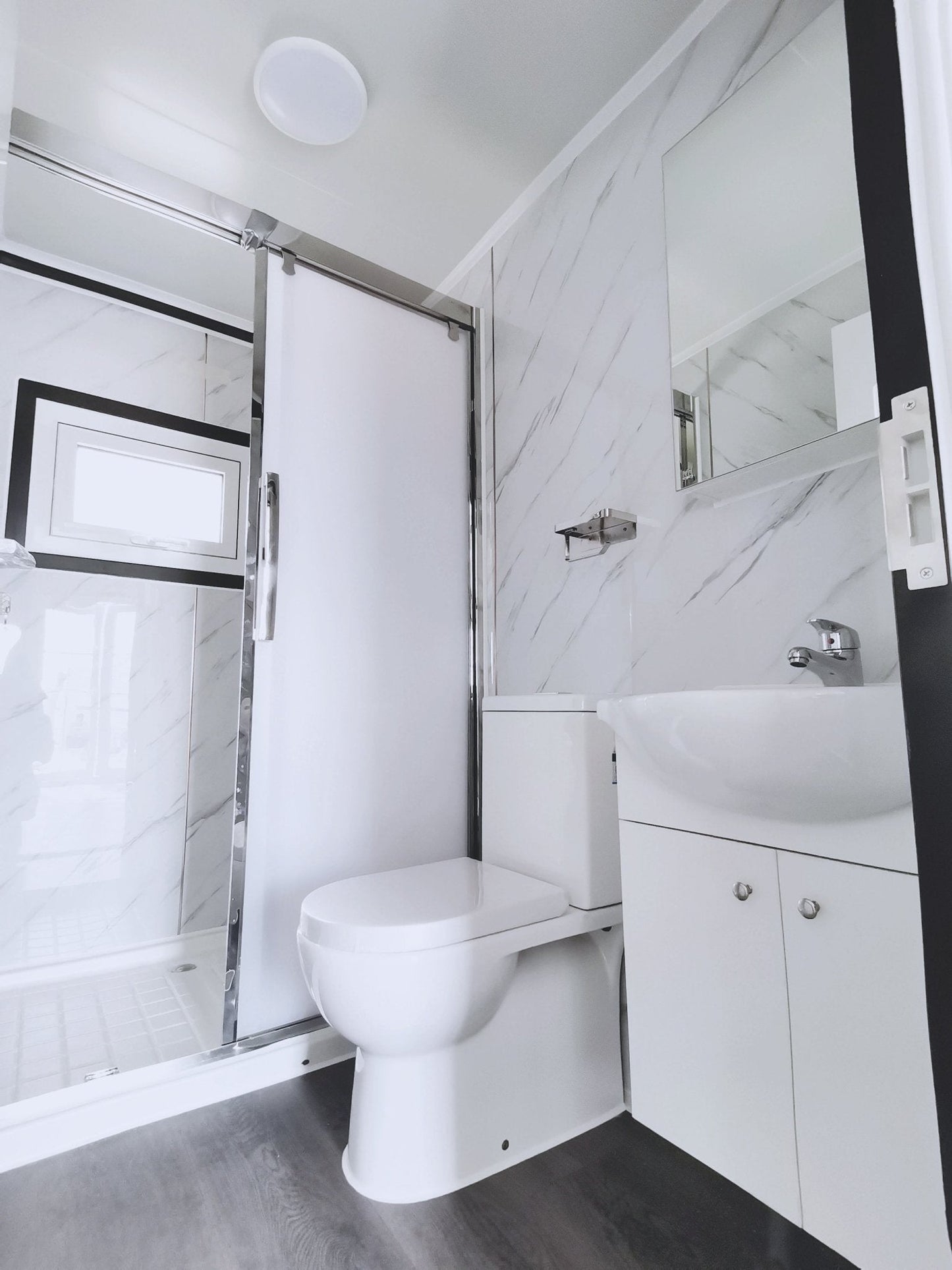 Exterior view of 2-bedroom deluxe folding house

Modern prefabricated orange modular home

Inside view of compact folding prefab unit

Kitchen area with electric setup in prefab home

Folding house with porch roof kit variant