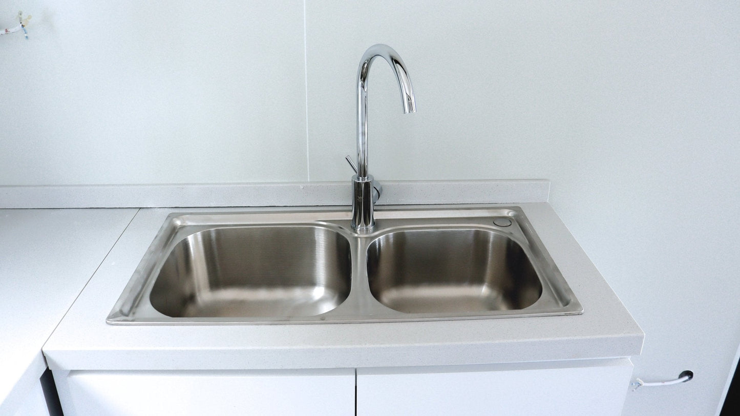 Exterior view of 2-bedroom deluxe folding house

Modern prefabricated orange modular home

Inside view of compact folding prefab unit

Kitchen area with electric setup in prefab home

Folding house with porch roof kit variant