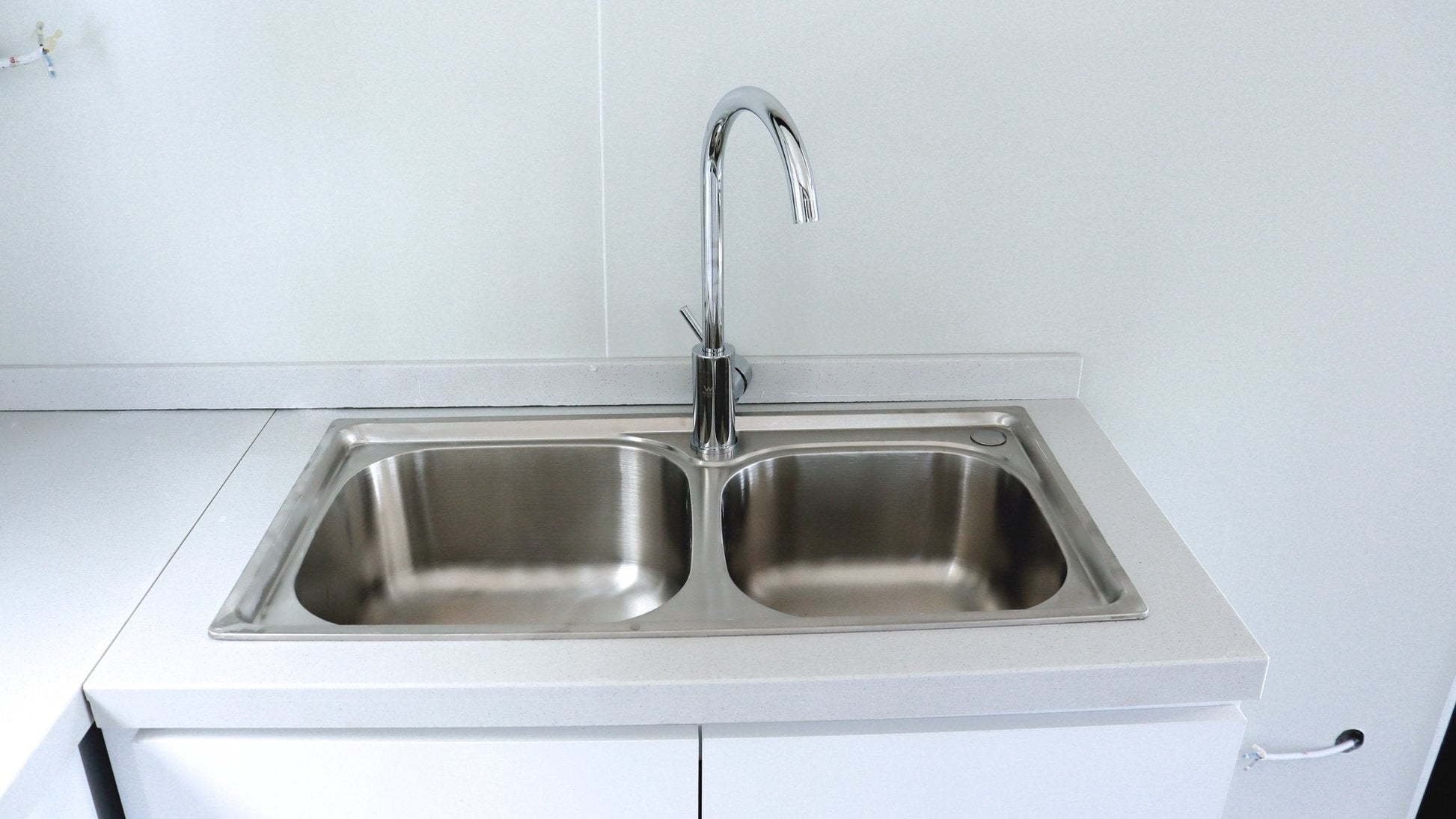 Exterior view of 2-bedroom deluxe folding house

Modern prefabricated orange modular home

Inside view of compact folding prefab unit

Kitchen area with electric setup in prefab home

Folding house with porch roof kit variant