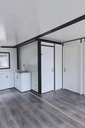Exterior view of 2-bedroom deluxe folding house

Modern prefabricated orange modular home

Inside view of compact folding prefab unit

Kitchen area with electric setup in prefab home

Folding house with porch roof kit variant