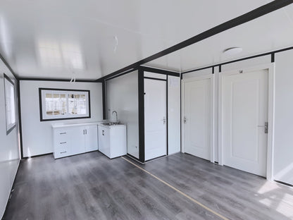 Exterior view of 2-bedroom deluxe folding house

Modern prefabricated orange modular home

Inside view of compact folding prefab unit

Kitchen area with electric setup in prefab home

Folding house with porch roof kit variant