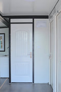 Exterior view of 2-bedroom deluxe folding house

Modern prefabricated orange modular home

Inside view of compact folding prefab unit

Kitchen area with electric setup in prefab home

Folding house with porch roof kit variant