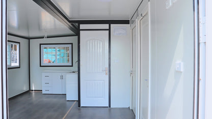 Exterior view of 2-bedroom deluxe folding house

Modern prefabricated orange modular home

Inside view of compact folding prefab unit

Kitchen area with electric setup in prefab home

Folding house with porch roof kit variant