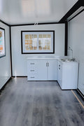 Exterior view of 2-bedroom deluxe folding house

Modern prefabricated orange modular home

Inside view of compact folding prefab unit

Kitchen area with electric setup in prefab home

Folding house with porch roof kit variant