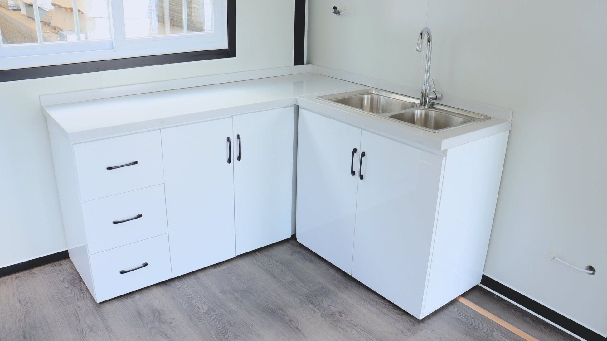 Exterior view of 2-bedroom deluxe folding house

Modern prefabricated orange modular home

Inside view of compact folding prefab unit

Kitchen area with electric setup in prefab home

Folding house with porch roof kit variant