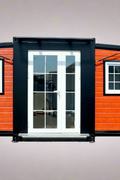 Exterior view of 2-bedroom deluxe folding house

Modern prefabricated orange modular home

Inside view of compact folding prefab unit

Kitchen area with electric setup in prefab home

Folding house with porch roof kit variant