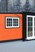 Exterior view of 2-bedroom deluxe folding house

Modern prefabricated orange modular home

Inside view of compact folding prefab unit

Kitchen area with electric setup in prefab home

Folding house with porch roof kit variant