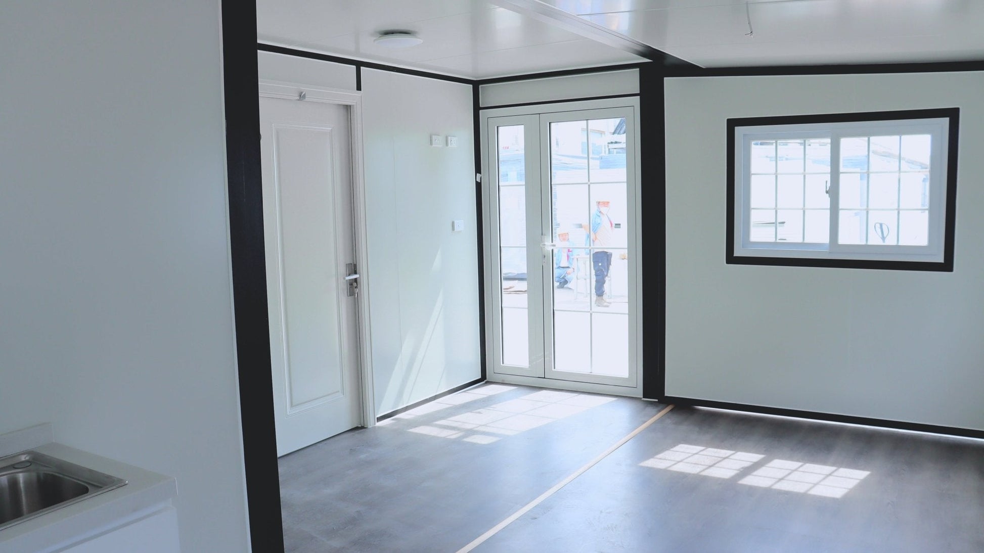 Exterior view of 2-bedroom deluxe folding house

Modern prefabricated orange modular home

Inside view of compact folding prefab unit

Kitchen area with electric setup in prefab home

Folding house with porch roof kit variant