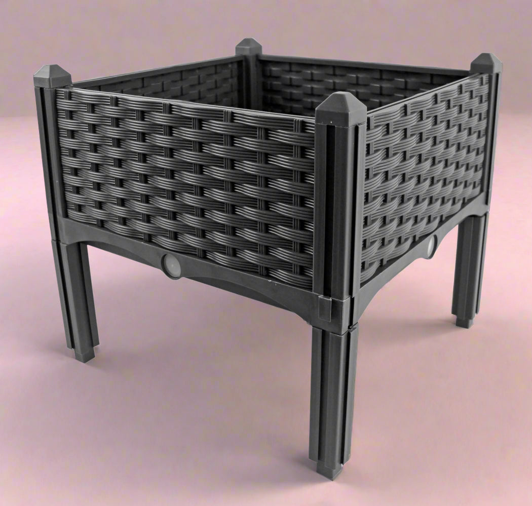 Self-watering elevated garden bed planter for balcony

Raised garden box with overflow drainage system

Plastic planter with water reservoir and brown finish

Compact elevated planter box for herbs and vegetables

Snap-together plastic raised garden bed design