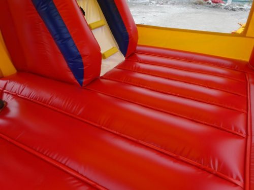 Red and blue bouncy castle with inflatable slide for commercial rental
18 ft long PVC inflatable bounce house and slide combo
Durable rental-grade inflatable with blower and safety features
Side view of heavy-duty bouncy castle in vibrant colors
Inflatable slide combo designed for kids' events and parties