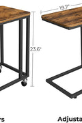 Rustic side table with laptop on top near sofa
Rolling wood TV tray with black metal legs
End table with wheels next to couch
Industrial-style side table for laptop and coffee