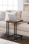 Rustic side table with laptop on top near sofa
Rolling wood TV tray with black metal legs
End table with wheels next to couch
Industrial-style side table for laptop and coffee