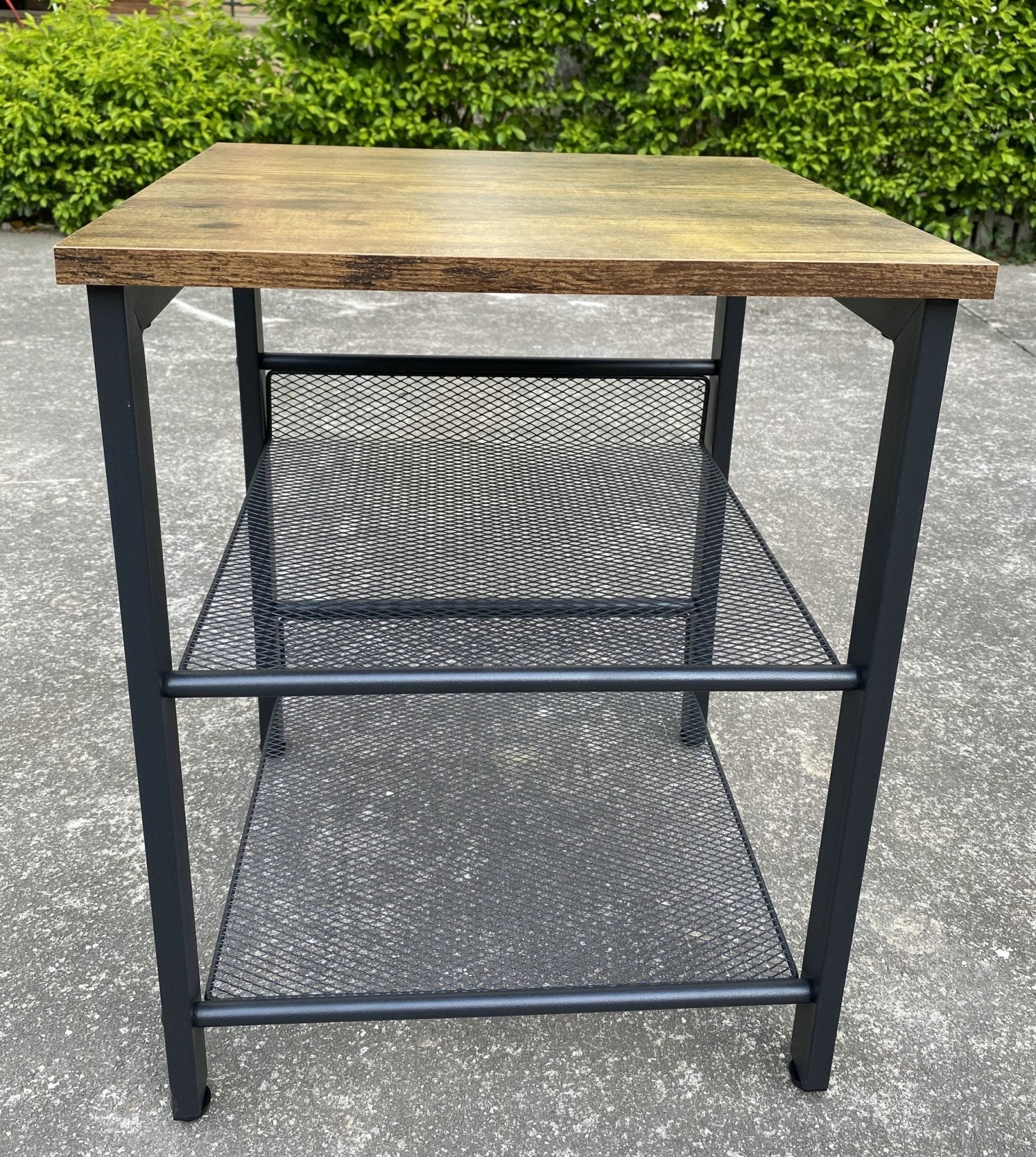 Rustic end tables in a cozy living room setting with sofa and lamp

Side View: Square wood top table with black mesh shelf

Angled View: Rustic wood and black metal table with adjustable shelf

Front View: Front profile of industrial end table with wood top and mesh shelf

Top View: Close-up of wood grain tabletop with rounded edges